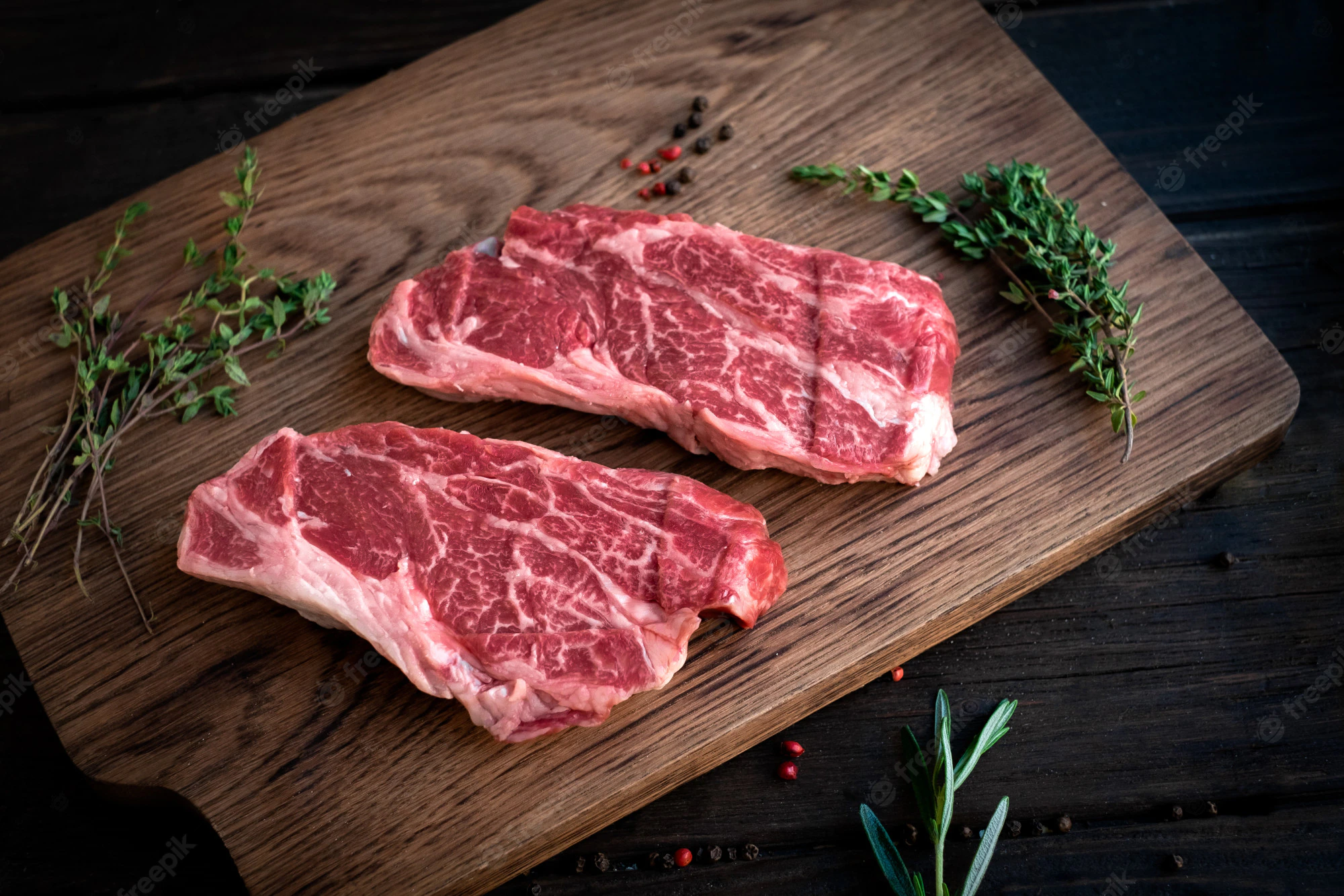 raw-chuck-roll-steaks-premium-beef-with-seasonings-wooden-board-top-view-rustic-stule_94053-1